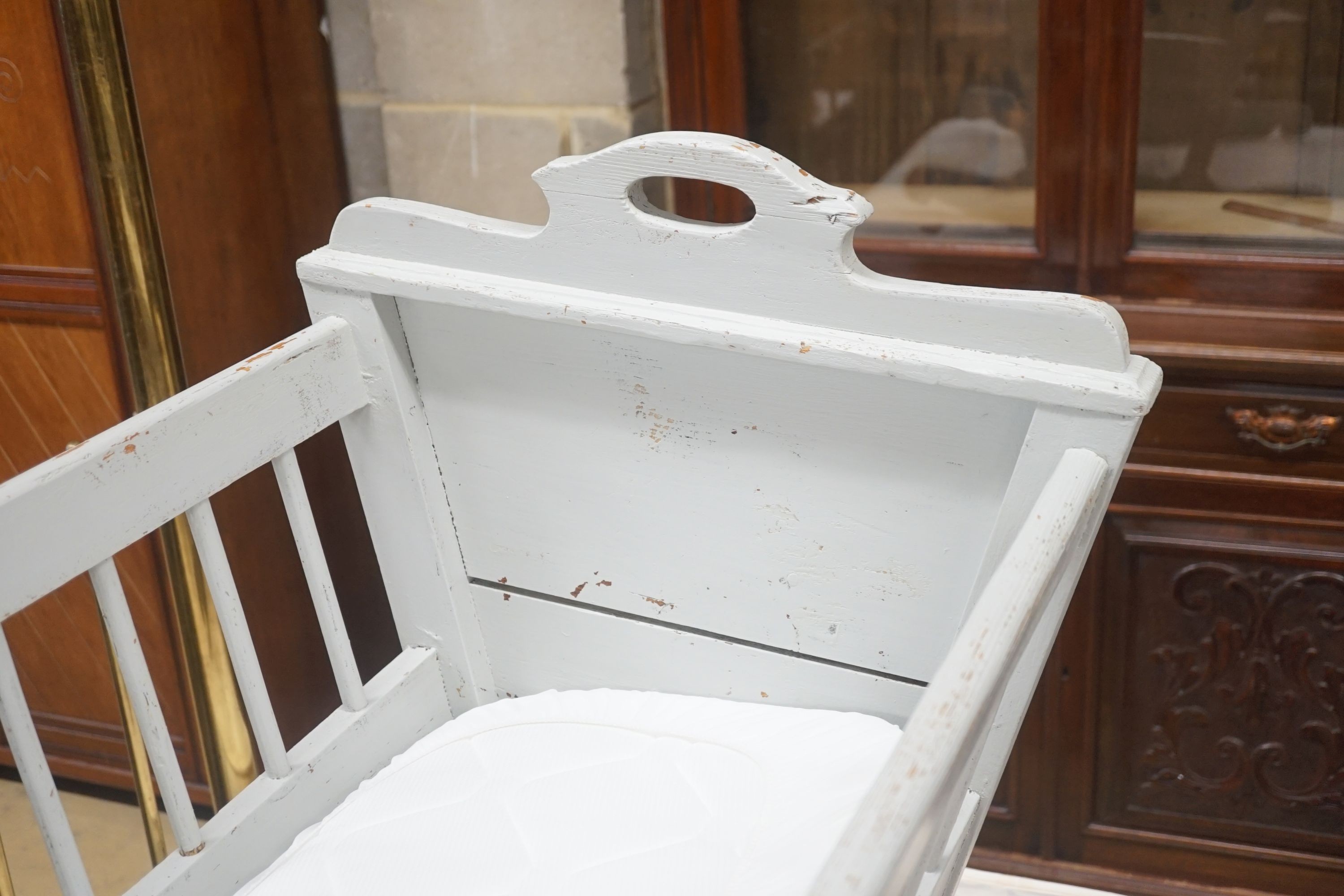 A 19th century Continental painted pine rocking crib, length 94cm width 85cm